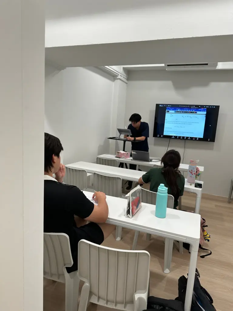 Students attending HL/SL Physics class in a modern classroom setting.