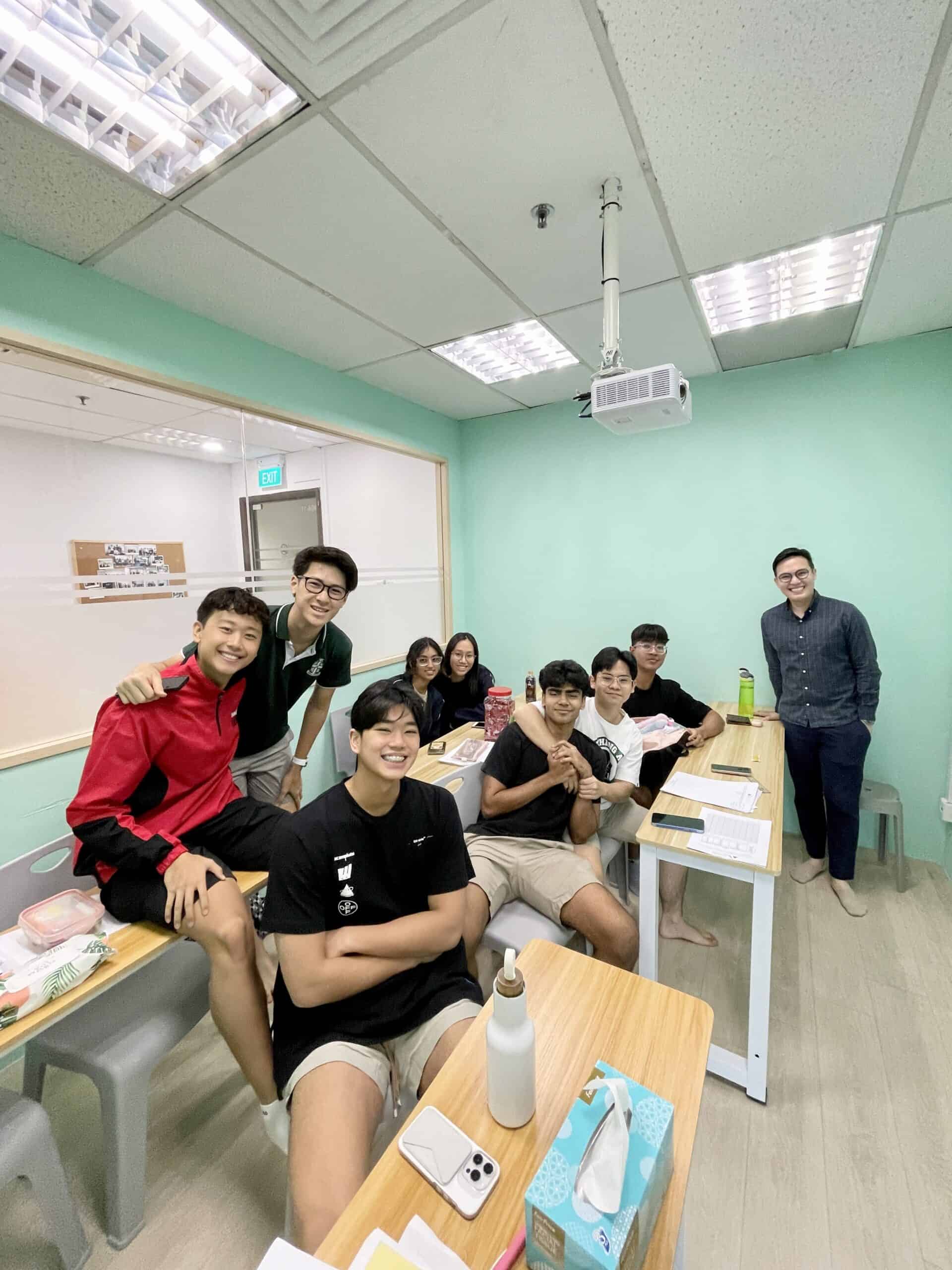 Group of students studying in a classroom at Axiom Education.