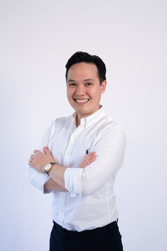 Professional portrait of Suah Boon Choong in white shirt smiling confidently.