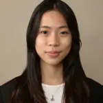 Portrait of a young Asian woman with long dark hair and a gentle smile.