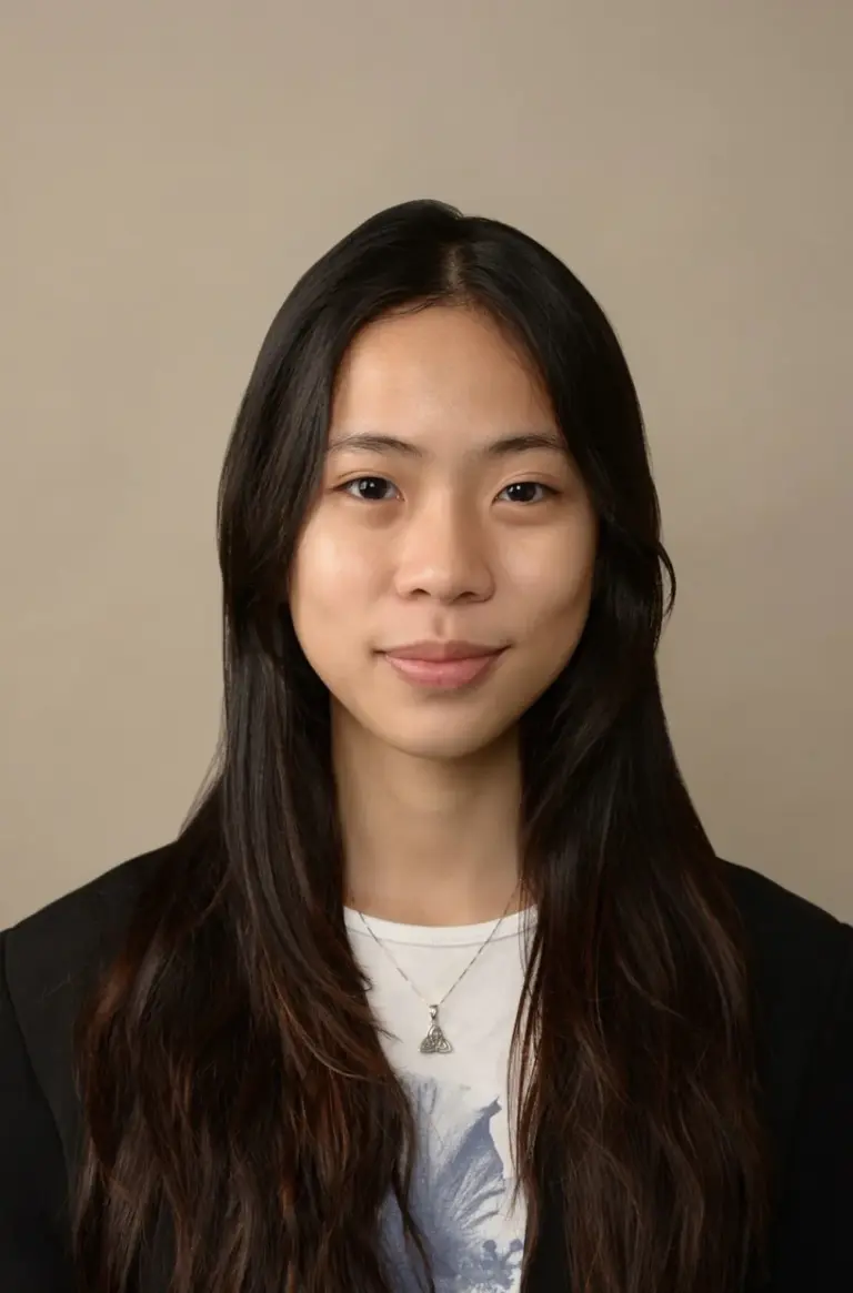 Portrait of a young Asian woman with long dark hair and a gentle smile.