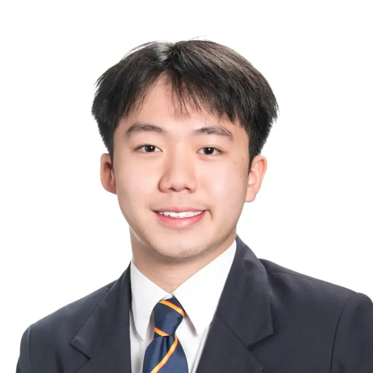 Young man in formal suit smiling for professional portrait.